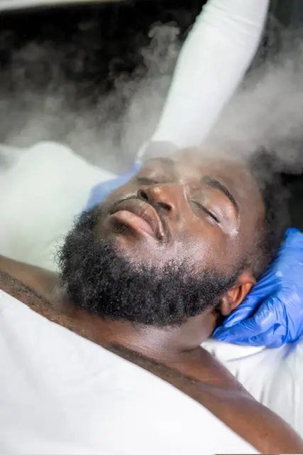 A client receiving steam during a customized facial